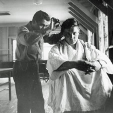 Pfc. Domenic D'Alessandris giving a haircut