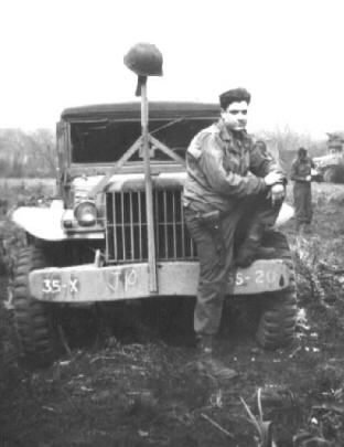 Sgt. Charles R. Woodfall in front of 35th Div Command car