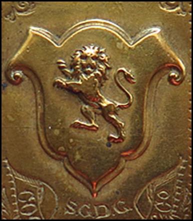 A gold rectangular object with a lion on it
Description automatically generated