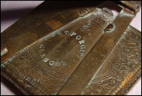 A close-up of a brass book
Description automatically generated