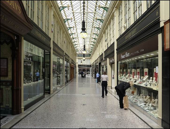 People inside a mall with many stores
Description automatically generated