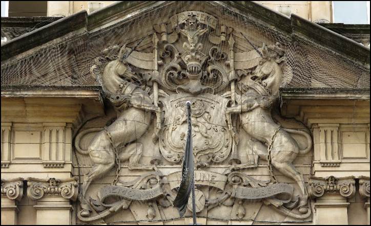 A stone building with a shield and a sword
Description automatically generated with medium confidence