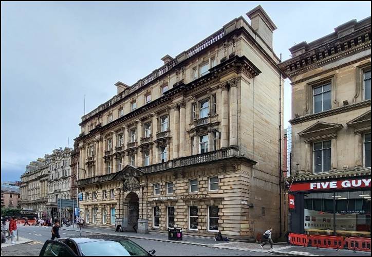 A building next to a street
Description automatically generated