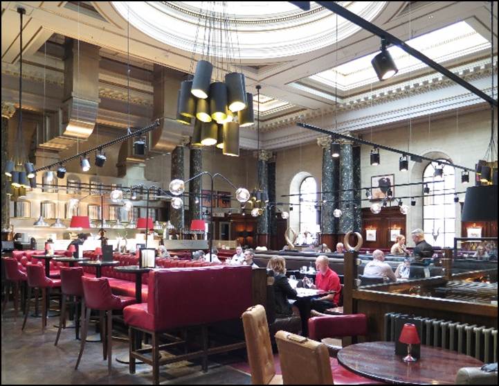 A restaurant with many tables and chairs
Description automatically generated