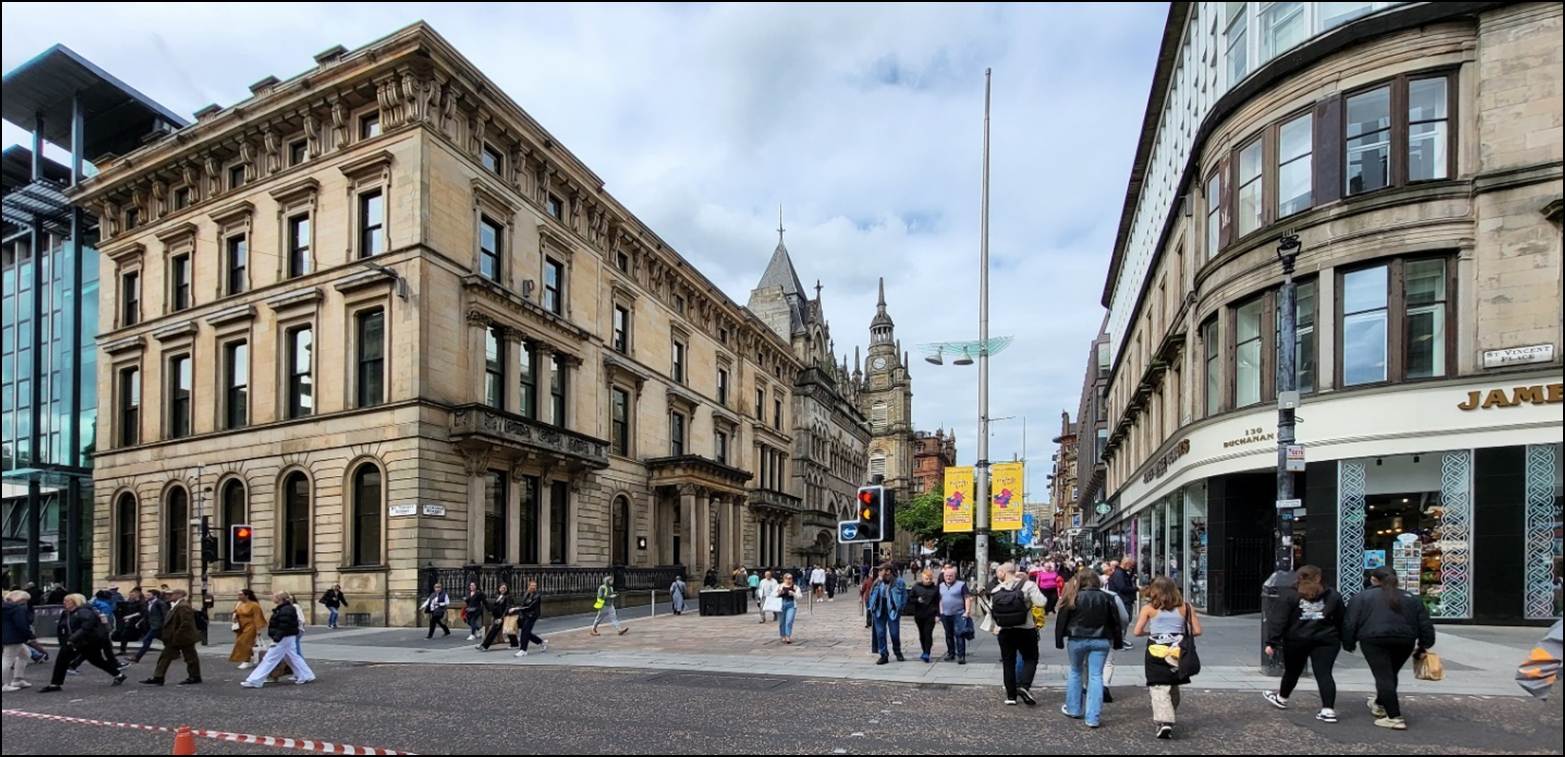 A group of people walking in a city street
Description automatically generated