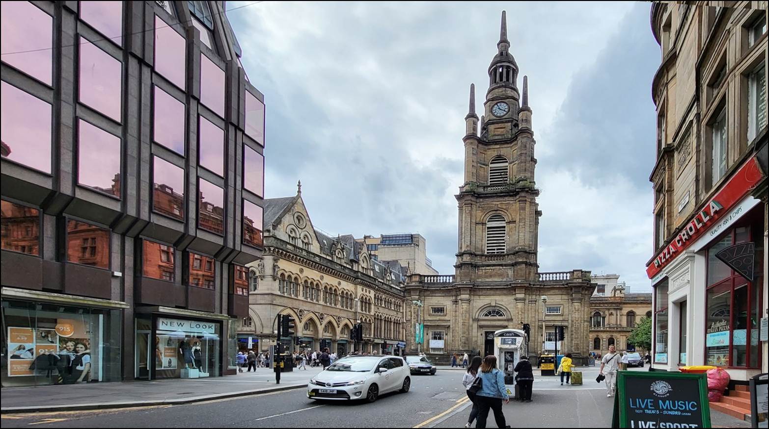 A clock tower in a city
Description automatically generated