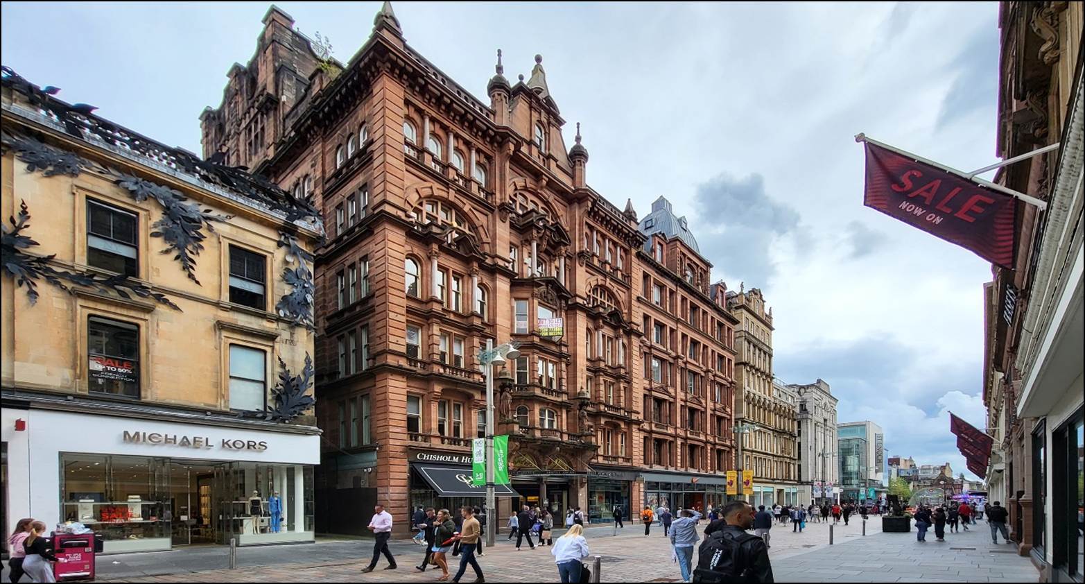 A group of people walking in a city
Description automatically generated