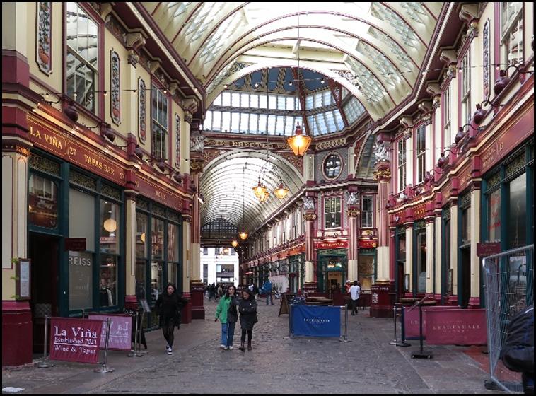 People walking in a shopping mall with Leadenhall Market in the background
Description automatically generated