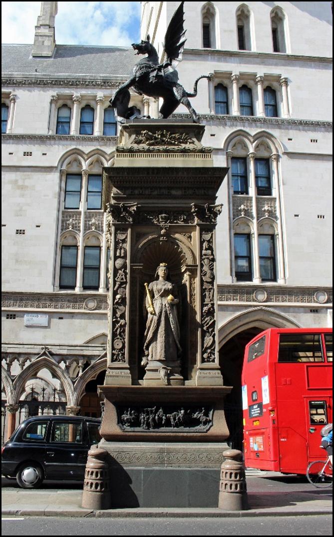 A statue of a person in front of a building

Description automatically generated