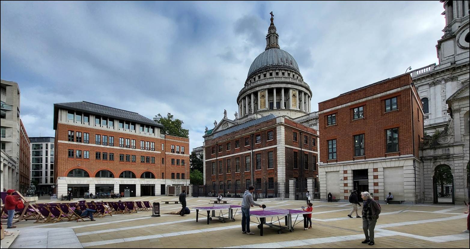 A group of people playing table in a courtyard
Description automatically generated