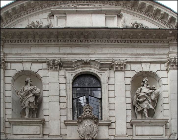 A stone building with statues on the front
Description automatically generated