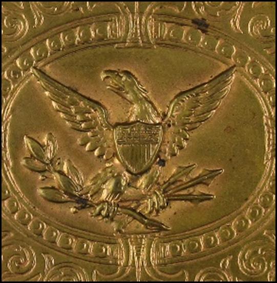 A gold square object with a symbol on it
Description automatically generated