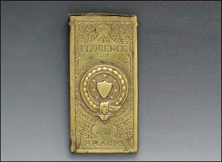 A gold rectangular object with a shield and a shield on it
Description automatically generated