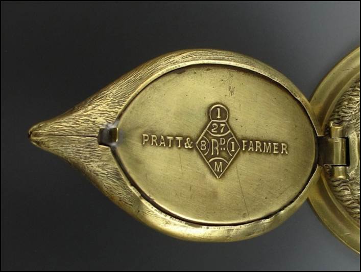 A close-up of an antique brass object
Description automatically generated