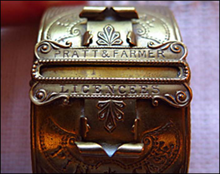 A close-up of a brass bracelet
Description automatically generated