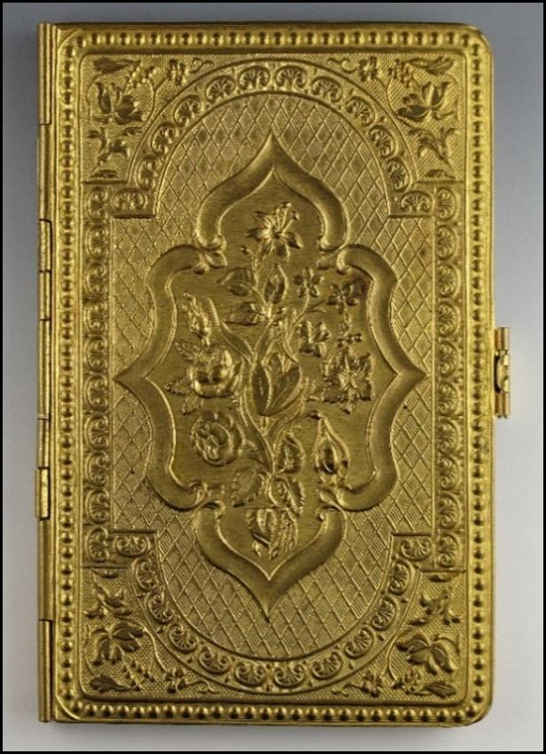 A gold colored rectangular object with a floral design

Description automatically generated with medium confidence