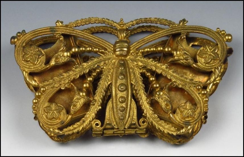 A gold butterfly shaped object

Description automatically generated