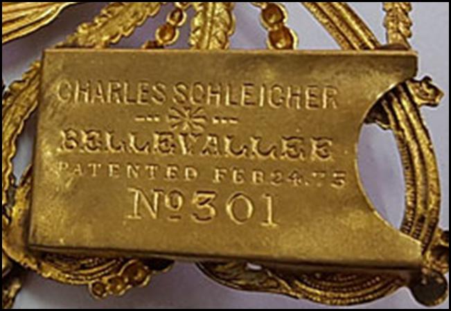 A gold plate with text on it

Description automatically generated