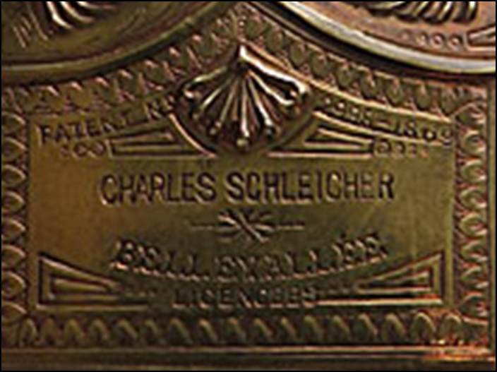 A gold colored metal case with a tag

Description automatically generated